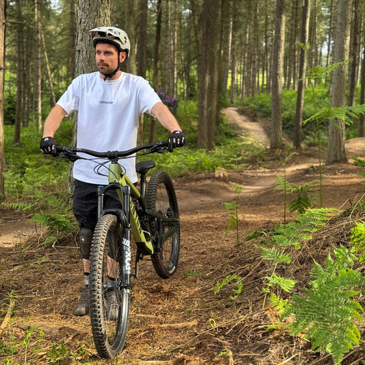 Man riding a mountain bike on a trail in a forest