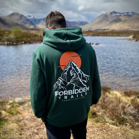 man standing with green hoodie with mountain graphic on back