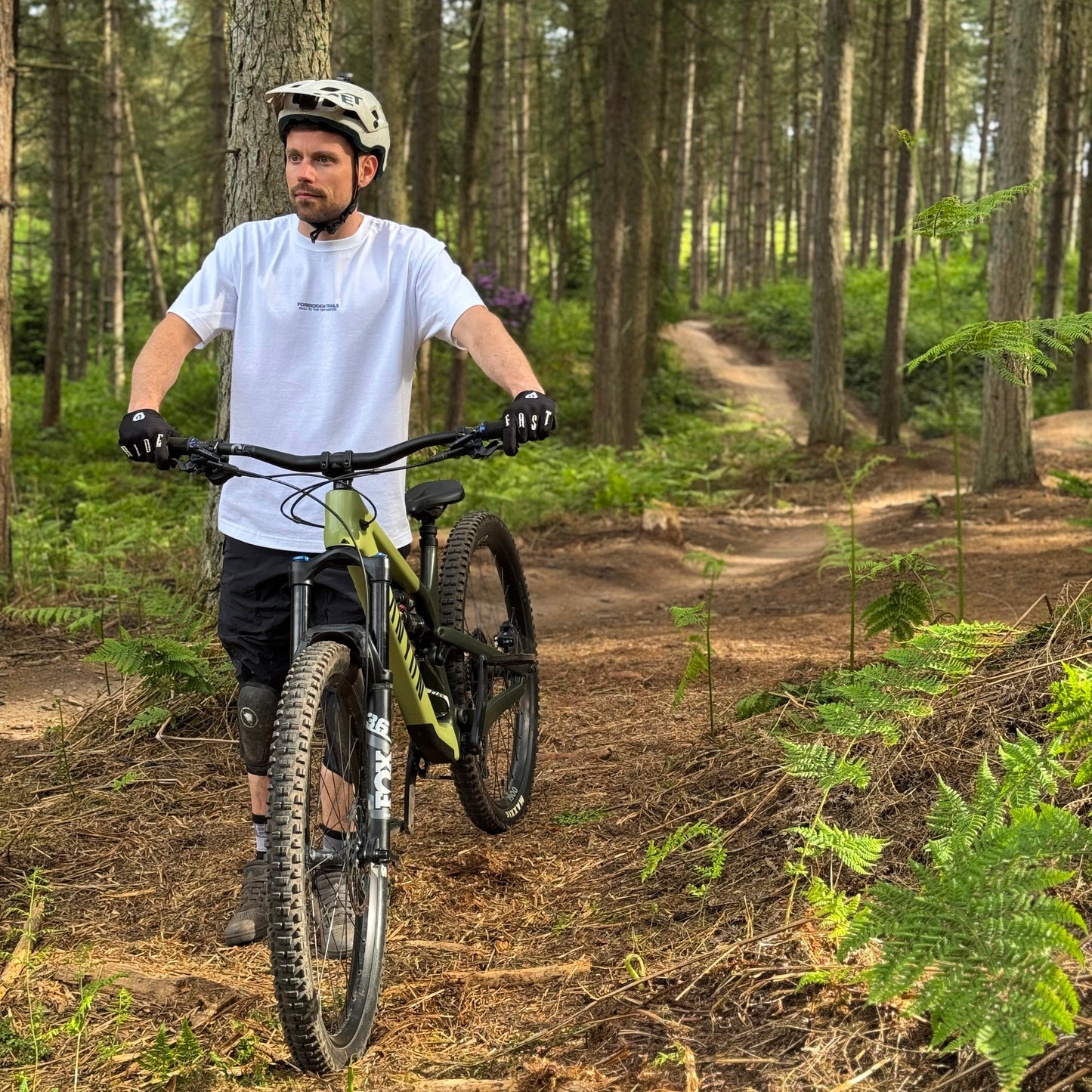 Man riding a mountain bike on a trail in a forest
