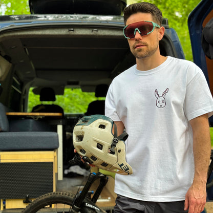 Man holding a helmet next to an open van with a bike