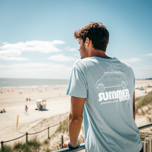 Man wearing a light blue t-shirt with 'Summer Ready' text at the beach